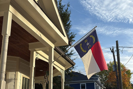North Carolina state flag displayed from a porch in Historic Oakwood, Raleigh