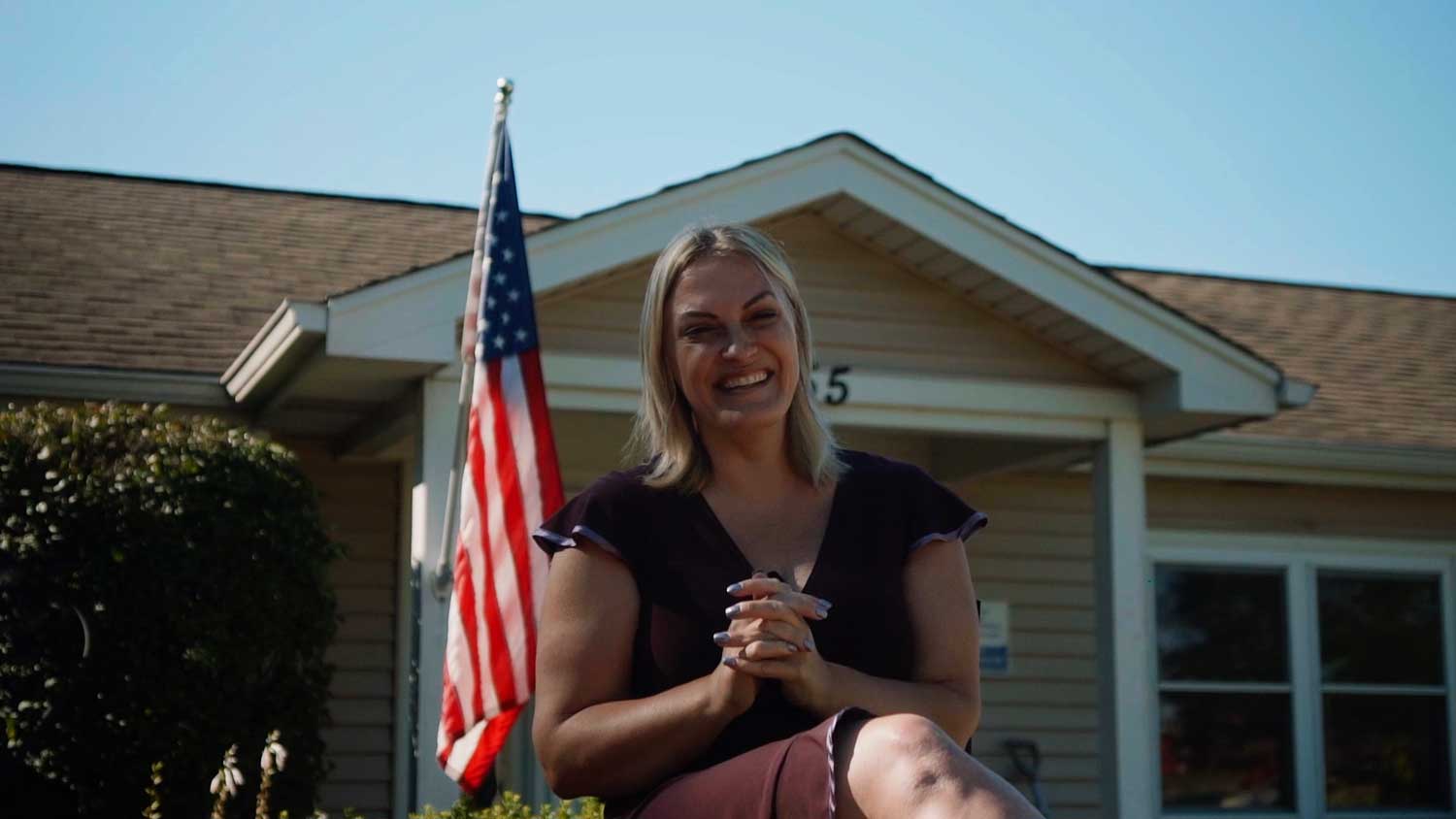 Kim Dacka, in front of Flags USA, in the "100% made in the USA" flag series