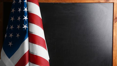 American flag displayed in a classroom setting, symbolizing respect, unity, and national pride among students.