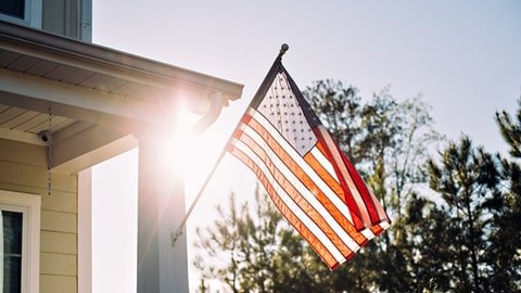 Outdoor flag set on house flying American flag