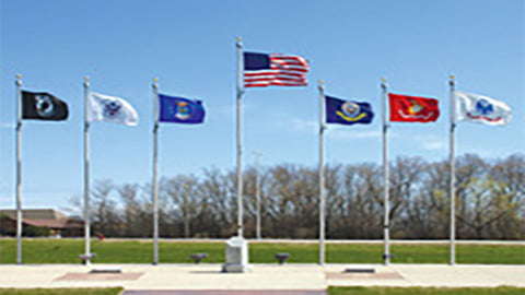 Commercial flag poles flying American and military flags